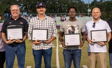 Shayne Morgan (from left), Robby Howell, Darius Wright and Derek Case were inducted into the Fort White High Athletics Hall of Fame on Friday night. Sitia Martinez, who was not in attendance, was also inducted. (JACK HOWDESHELL/Special to the Reporter)