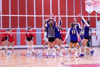 Columbia celebrates a point against Lafayette on Tuesday night. (JACK HOWDESHELL/Special to the Reporter)