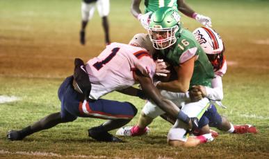 Suwannee receiver Noah Lopez is tackled by Wakulla safety Jeremiah Thomas and another defender on Friday. (PAUL BUCHANAN/Lake City Reporter)