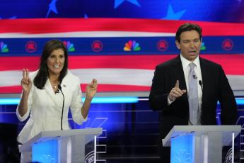 Former U.N. Ambassador Nikki Haley and Florida Gov. Ron DeSantis talk during a Republican presidential primary debate on Wednesday at the Adrienne Arsht Center for the Performing Arts of Miami-Dade County in Miami. (REBECCA BLACKWELL/Associated Press)