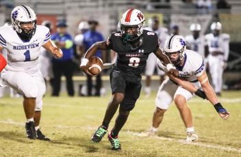 Fort White quarterback Jayden Jackson scrambles up the field against Ridgeview on Oct. 20. (BRENT KUYKENDALL/Lake City Reporter)