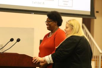Van Brown, the county’s new economic development specialist, smiles as Economic Development Director Jennifer Daniels introduces her at Thursday’s County Commission meeting. (JAMIE WACHTER/Lake City Reporter)