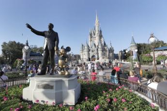 A statue of Walt Disney and Mickey Mouse appears in front of the Cinderella Castle at the Magic Kingdom theme park at Walt Disney World in Lake Buena Vista. (JOHN RAOUX/Associated Press)