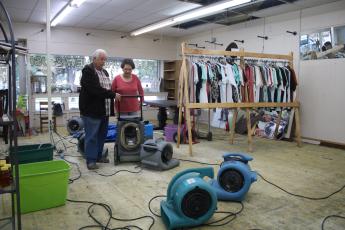 Buck Strickland (from left) and Linda Odom, owners of Furnishings on Marion, look over various blowers that were put in the store to dry its interior after it received extensive water damage. (TONY BRITT/Lake City Reporter)