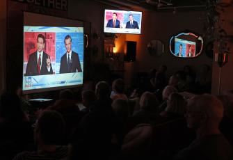 People watch a debate between California Gov. Gavin Newsom and Florida Gov. Ron DeSantis during a watch party at Manny’s on Thursday in San Francisco. Newsom and DeSantis were hosted by Sean Hannity on Fox. (JUSTIN SULLIVAN/Getty Images/TNS)