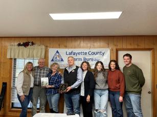 Gary Keyes and Johan Heijkoop and their families were honored as the Lafayette County Farm Bureau Farm Family of the Year at its Dec. 11 meeting. Pictured are Lafayette County Extension Ag Agent Emily Beach (from left), Gary Keyes, Kathy Keyes, Johan Heijkoop, Trisha Heijkoop, Jaylee Heijkoop, Julia Heijkoop and Jozef Heijkoop. Not pictured is Johanna Heijkoop. (COURTESY)
