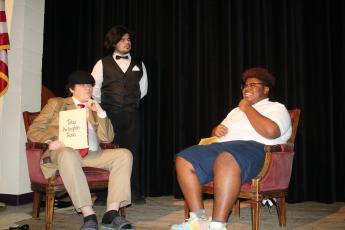 Nickolas Stewart (from left), Gian Rivera, portraying a detective and butler, question Schmari Lockley  during dress rehearsal for The Alibis, a Columbia High School theater production that will take place this weekend. (TONY BRITT/Lake City Reporter)
