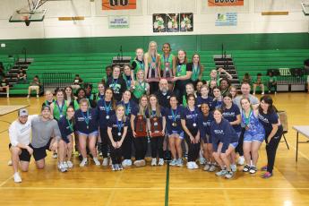 District 4-1A champion Suwannee and district runner-up Maclay pose with their district trophies on Friday. (PAUL BUCHANAN/Special to the Reporter)