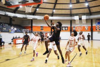 Columbia forward Zavian Douglas goes up for a shot against Orange Park on Friday night. (MORGAN MCMULLEN/Lake City Reporter)