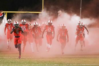 Fort White quarterback Jayden Jackson leads his team on to the field prior to the Region 3-1A semifinal against Union County last season. (BRENT KUYKENDALL/Lake City Reporter)