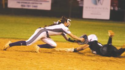 Columbia shortstop Lillyenne Mayhew applies a late tag to Baldwin shortstop Amiyah Jones during the Tigers’ 9-0 loss on Friday. (MORGAN MCMULLEN/Lake City Reporter)