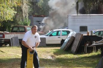 Lake City Assistant Fire Chief Dwight Boozer works with a hose at a fire. Boozer passed away Wednesday night after a battle with cancer. (FILE)