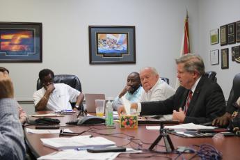 Robert Jones (from left), CareerSource Florida Crown Executive Director, Ron Jones, and Eugene Dukes, board chairman, listen intently as Guy Norris, Florida Crown legal counsel, talks about recent economic sanctions applied to the agency during the Wednesday morning’s CareerSource Florida Crown board meeting. (TONY BRITT/Lake City Reporter)