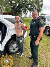 Samuel Sanders is handcuffed by Suwannee County Deputy Derek Slaughter after fleeing from an attempted stop and crashing in a stolen vehicle Wednesday. (COURTESY SCSO)