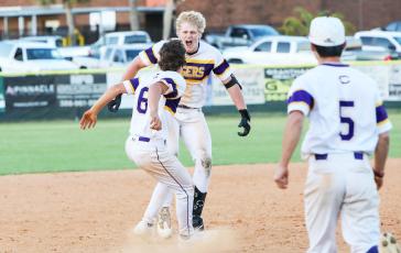 Columbia left fielder Max Schuler and pitcher Grant Bowers celebrate after Schuler hit a walk-off 2-RBI double to defeat Buchholz 11-10 on Friday. (BRENT KUYKENDALL/Lake City Reporter)