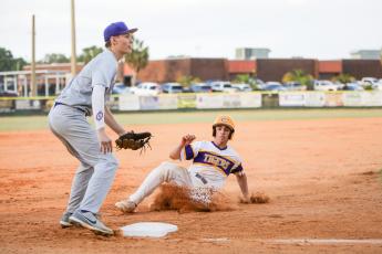 Columbia's Grant Bowers slides safely into third base during Tuesday's District 2-5A semifinal against Gainesville. (BRENT KUYKENDALL/Lake City Reporter)