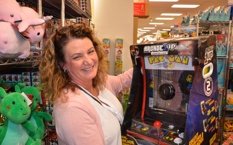 Bernadette Feickert eyes a miniature Pac-Man arcade machine at Belk on Friday morning. She wanted to get it for her 16-year-old, but imagined her two older sons would sneak turns on it, too. (CARL MCKINNEY/Lake City Reporter)