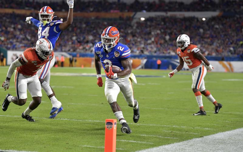 Florida’s Lamical Perine runs to the end zone for a touchdown against Virginia during the first half of the Orange Bowl on Monday, at Hard Rock Stadium. (MICHAEL LAUGHLIN/Sun Sentinel/TNS)