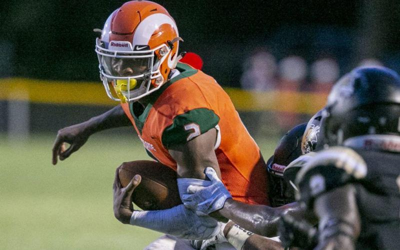 Eastside High quarterback Anthony Richardson evades a Buchholz defender during their game earlier this season at Citizens Field. (ALAN YOUNGBLOOD/TNS)