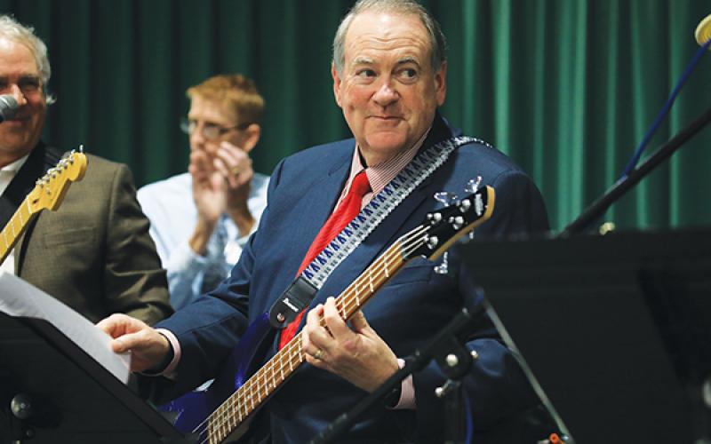 Former Arkansas Governor Mike Huckabee plays bass with local rockers Tuesday night at FGC. (CAMERON VINING/Special to the Reporter)