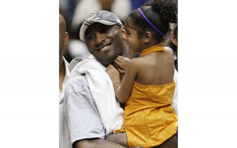 Los Angeles Lakers' Kobe Bryant holds his daughter, Gianna, after defeating the Orlando Magic 99-86 in Game 5 to win the NBA Finals on June 14, 2009 in Orlando. Bryant, the 18-time NBA All-Star who won five championships and became one of the greatest basketball players of his generation during a 20-year career with the Los Angeles Lakers, died in a helicopter crash Sunday. Gianna also died in the crash. (AP FILE PHOTO)