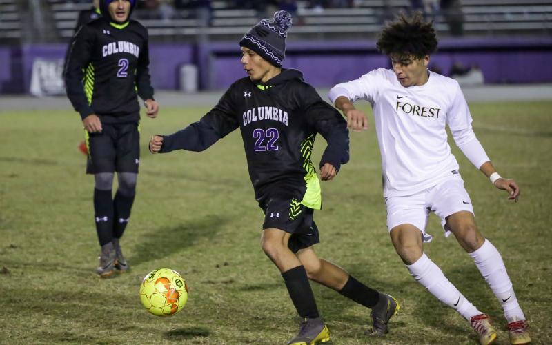 Columbia's Jason Caballero dribbles around Forest player on Tuesday night. The Tigers and Wildcats will face each other in the District 2-6A quarterfinals on Feb. 3. (BRENT KUYKENDALL/Lake City Reporter)