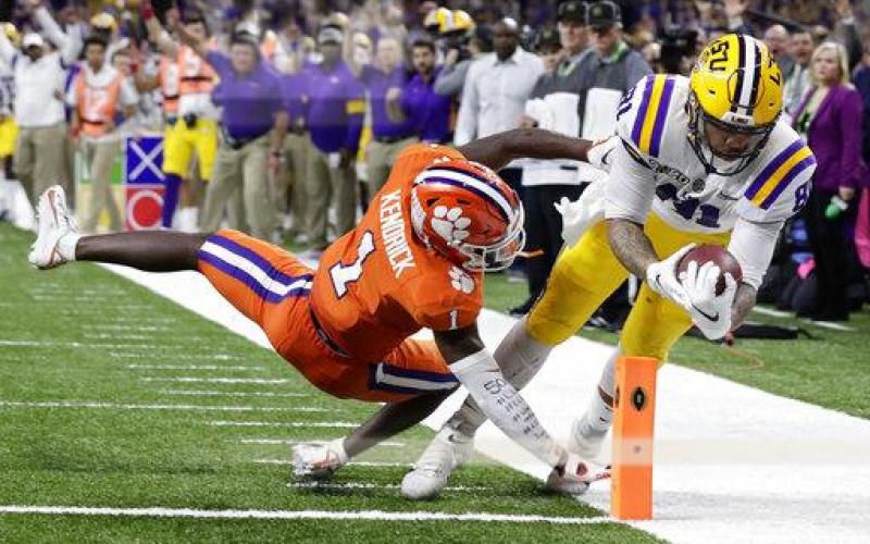 LSU tight end Thaddeus Moss scores a touchdown past Clemson cornerback Derion Kendrick during the second half of the College Football Playoff national championship game Monday, in New Orleans. (SUE OGROCKI/Associated Press)