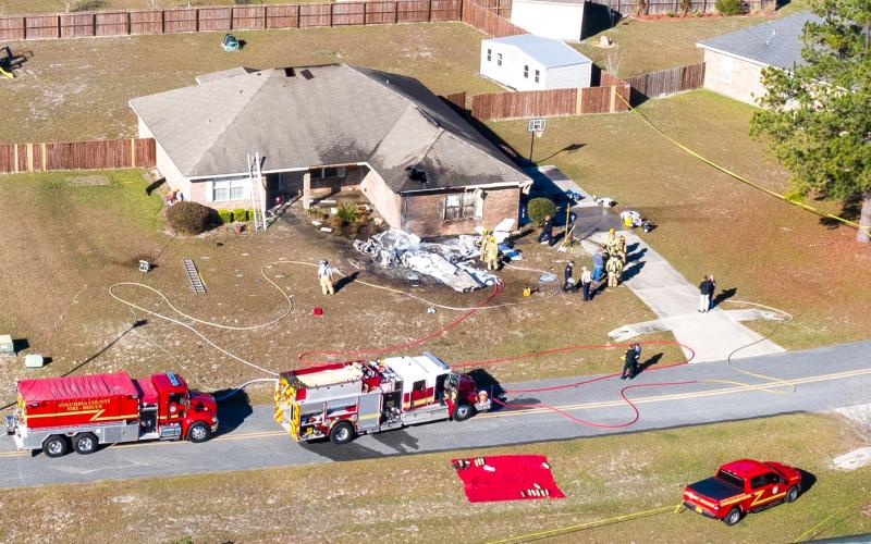 First responders are pictured at the scene shortly after a single-engine plane crashed into a Lake City home Saturday morning. (Ray Carpenter Photography)