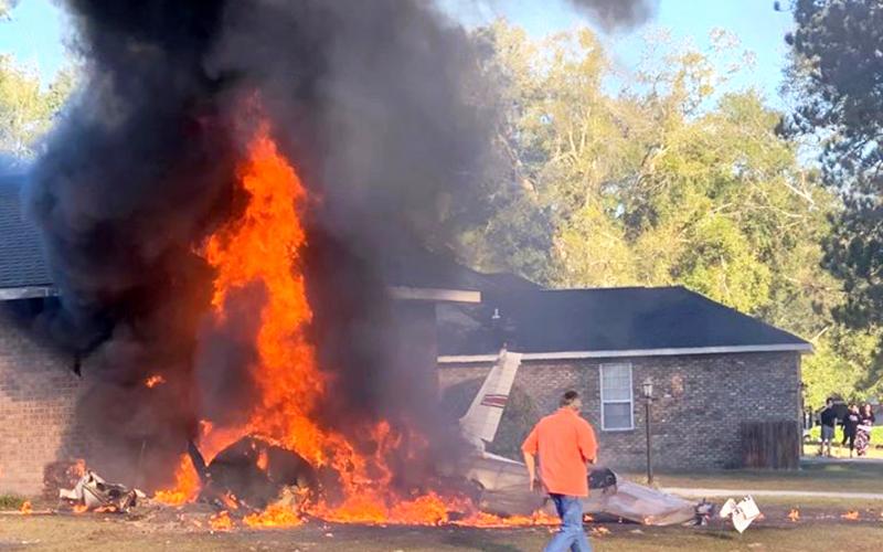 A single-engine plane is seen in flames after crashing into a home in Cannon Creek Airpark Saturday morning. (Photo courtesy of AMY BROWN/Facebook)