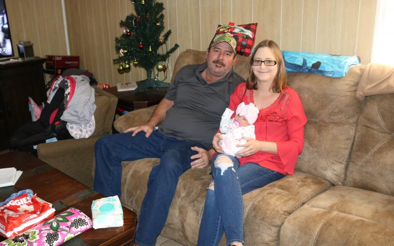Mike Fortune sits next to his partner Cindy Adams, who holds their newborn baby, Ariella. Adams gave birth to Ariella on the side of the road in Alachua County last month. (TONY BRITT/Lake City Reporter)