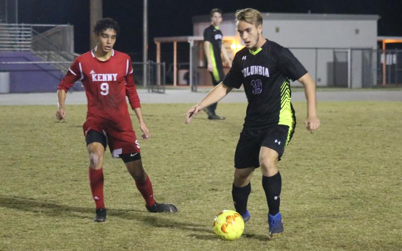Columbia’s Jakob North dribbles the ball up the field as Bishop Kenny’s Martin Pineiros rushes to defend. (ZACH ABOLVERDI/Lake City Reporter)