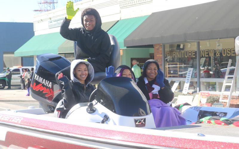 Children atop the Trinity United Methodist Church float wave at the crowd as the float heads down Marion Avenue during Monday’s MLK Jr. parade. (TONY BRITT/Lake City Reporter)