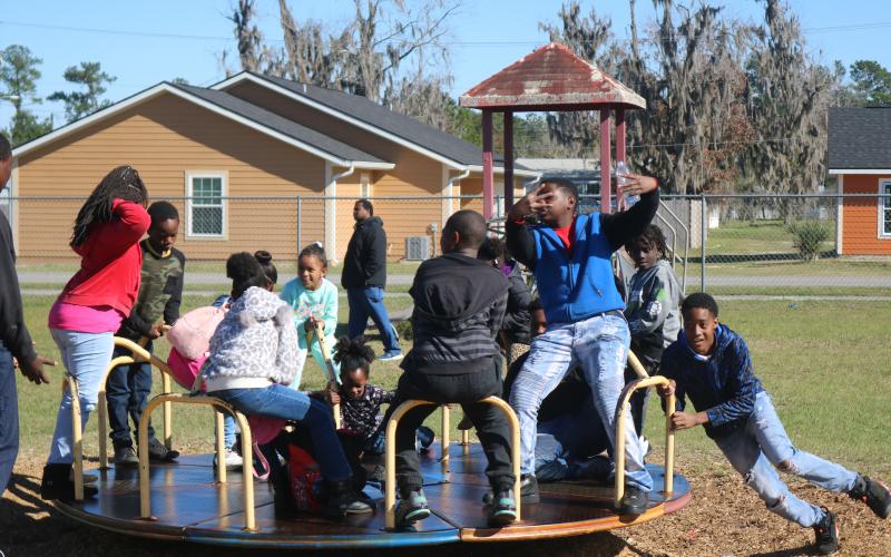 A youngster spins a group of friends at Annie Mattox Park on Monday during the Passion Through Action group’s Martin Luther King Jr. celebration. (TONY BRITT/Lake City Reporter)