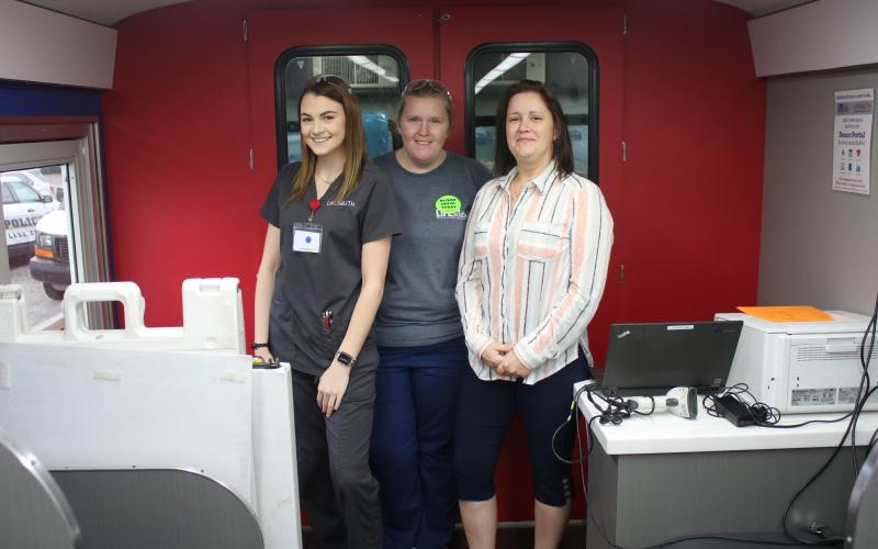 Bailee Mangrum, a donor services technician; Brittany Shehan, the donor services team leader; and Jessica Swartz, LifeSouth regional manager pose inside the blood mobile. “We always need blood,” Swartz told the Reporter. (MICHAEL PHILIPS/Lake City Reporter)