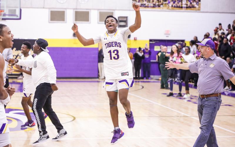 Columbia guard Tray Tolliver celebrates after defeating Daytona Beach Mainland 70-65 in Friday night’s Region 1-6A final. (BRENT KUYKENDALL/Lake City Reporter)