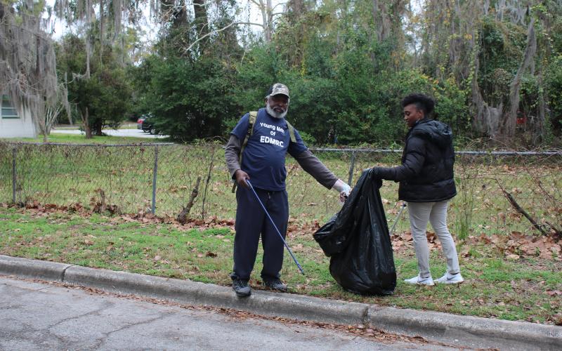 Harold Chatmon and Fertima Robinson collect trash on behalf of Lake City’s Evangelistic Deliverance Miracles Revival Center. Robinson traveled from Gainesville to help beautify Lake City. (MICHAEL PHILIPS/Lake City Reporter)