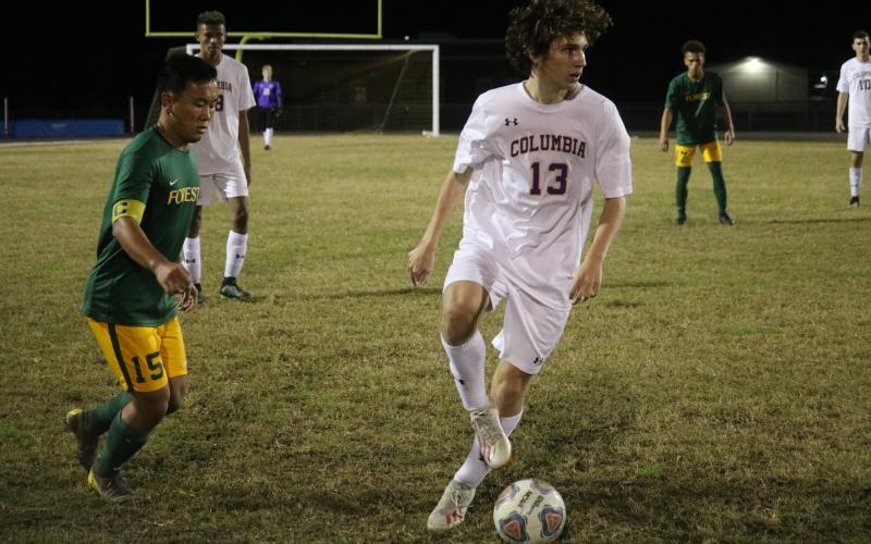 Columbia’s Tanner Pierce dribbles the ball away from Forest’s Marlon Rodriguez during Monday’s District 2-6A quarterfinals. (ZACH ABOLVERDI/Lake City Reporter)