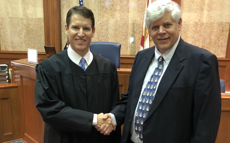 Interim Third Circuit State Attorney Dave Phelps shakes hands with Judge Mark Feagle after his swearing in December. (FILE)