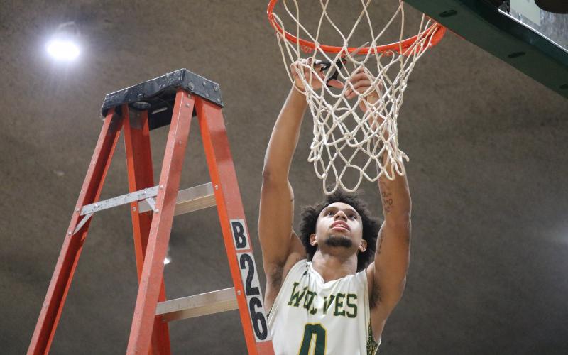 FGC guard Diamond Smith cuts down the nets after defeating Pasco-Hernando State College in the Divison II Region 8 championship on Saturday. (JORDAN KROEGER/Lake City Reporter)