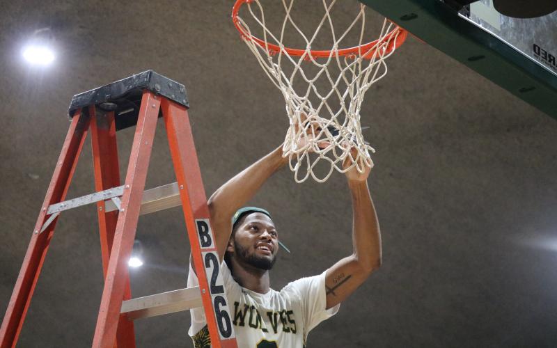 FGC guard Kenny Brown Jr. cuts down the nets after defeating Pasco-Hernando State College in the Divison II Region 8 championship on Saturday. (JORDAN KROEGER/Lake City Reporter)