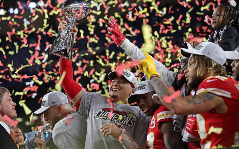Kansas City Chiefs quarterback Patrick Mahomes holds the Vince Lombardi Trophy after beating the San Francisco 49ers and winning the Super Bowl at Hard Rock Stadium. (JOHN McCALL/South Florida Sun Sentinel/TNS)