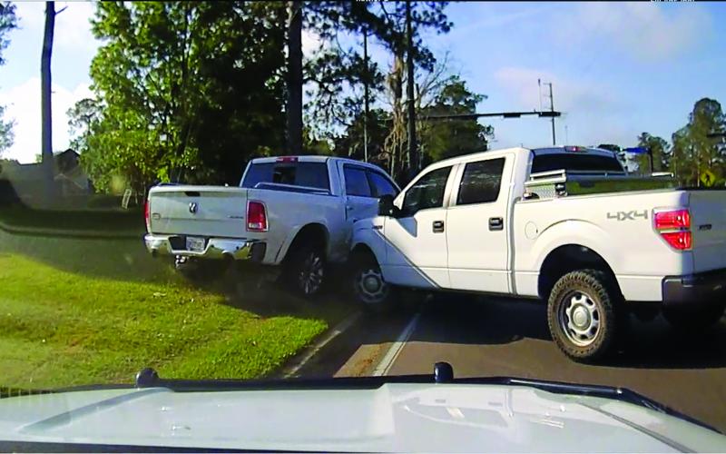 A stolen Dodge Ram pickup, left, is seen after it was spun out and wrecked in Gainesville. (COURTESY CCSO)