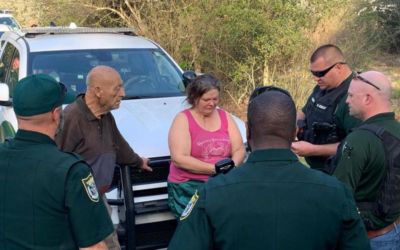 William Richard Grau, 77, the man in civilian garb pictured on the left, and his daughter, Cheryl Grau Articas, 52, pictured to his left, are arrested Tuesday. The investigation began with an anonymous call in December. (Photos courtesy SCSO)
