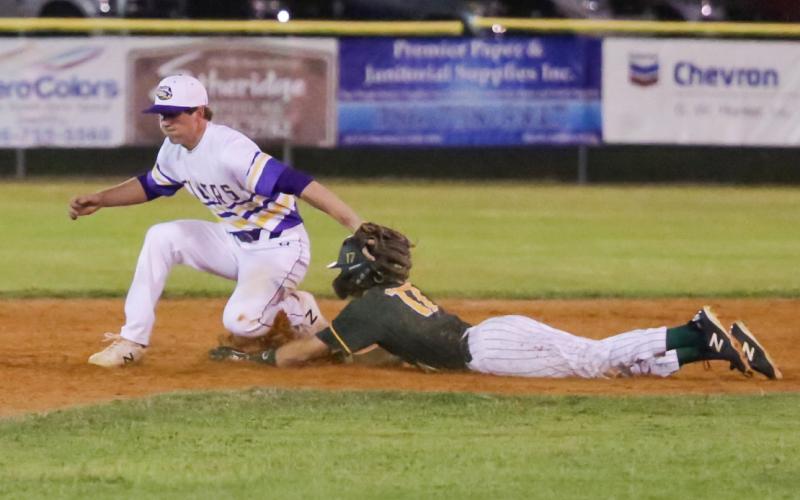 Columbia shortstop Kade Jackson applies the tag late as Forest's Bradley White II slides safely into second base. (BRENT KUYKENDALL/Lake City Reporter)