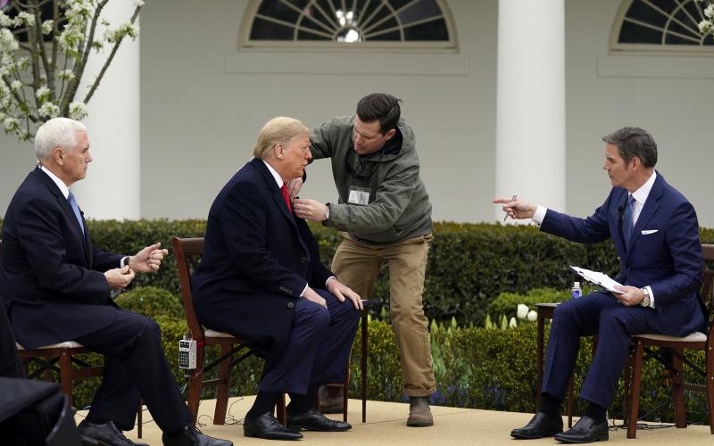 President Donald Trump arrives and speaks with Fox News Channel Anchor Bill Hemmer during a Fox News Channel virtual town hall at the White House Tuesday. (EVAN VUCCI/Associated Press)