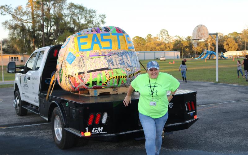 Pamela Hartopp, the Eastside Elementary paraprofessional who spearheaded the effort, poses for a picture with a 1,310 lb. ball of tape. That’s 690 pounds short of the current world record, so they’ll get back at it Saturday. (TONY BRITT/Lake City Reporter)