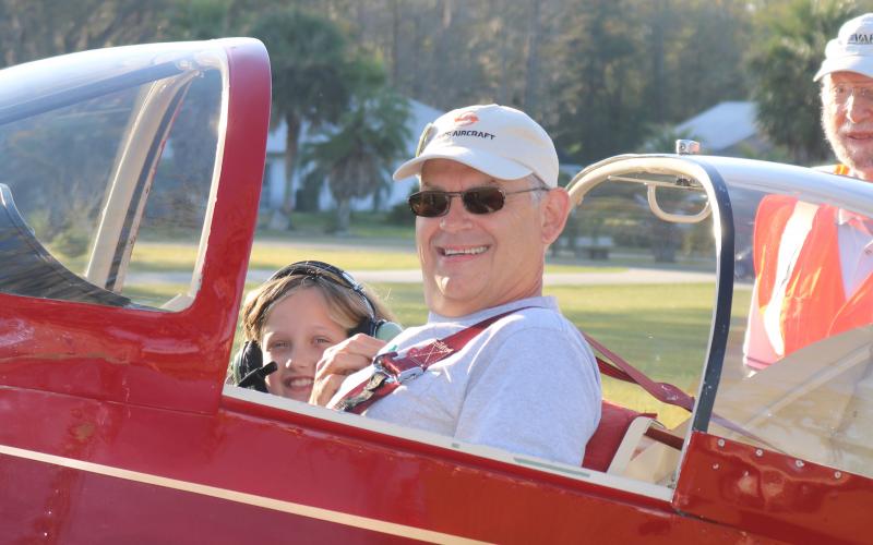 Mark Wiencek and Symphony Green, 8, get ready to take off from Cannon Creek Airpark and fly over Lake City as part of the Experimental Aircraft Association’s Young Eagles Rally on Saturday. (AMY HIETT/Special to the Reporter)