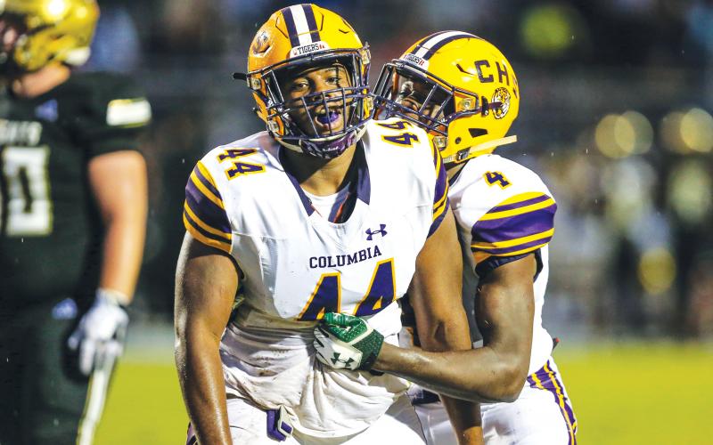 Columbia defensive lineman Terrick Ponds (44) is congratulated by linebacker Le’vontae Camiel (4) after a tackle for loss against Oakleaf on Aug. 30, 2019. (FILE)