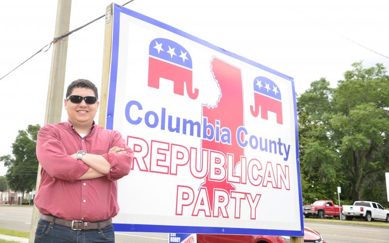 Columbia County GOP Chairman Hunter Peeler poses in front of the local Republican headquarters. The 21-year-old has been chosen to be a delegate at the Republican National Convention in North Carolina this August. (CARL MCKINNEY/Lake City Reporter)