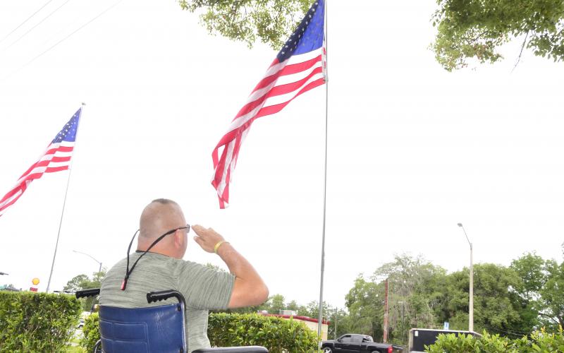 Larry Carter, a retired Army airborne infantryman, salutes the flag on Memorial Day outside the Lake City VA hospital. (CARL MCKINNEY/Lake City Reporter)